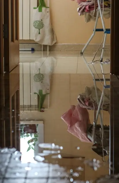 Water damage due a broken pipe. Moisture problem and wet floor. Horizontal, selective focus.